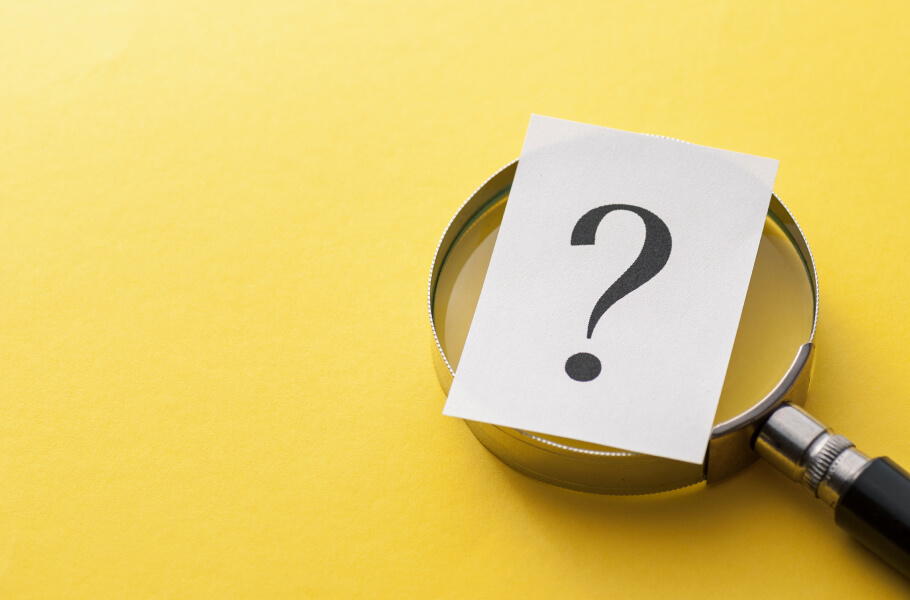 A big question mark above the magnifying glass