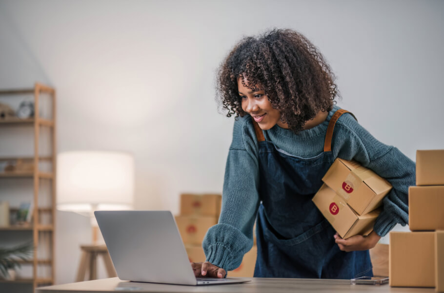 A businesswoman checks orders on her laptop