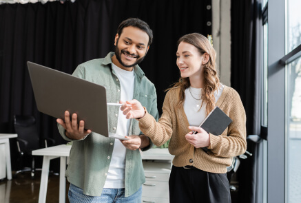 A couple choosing a something on displayed laptop