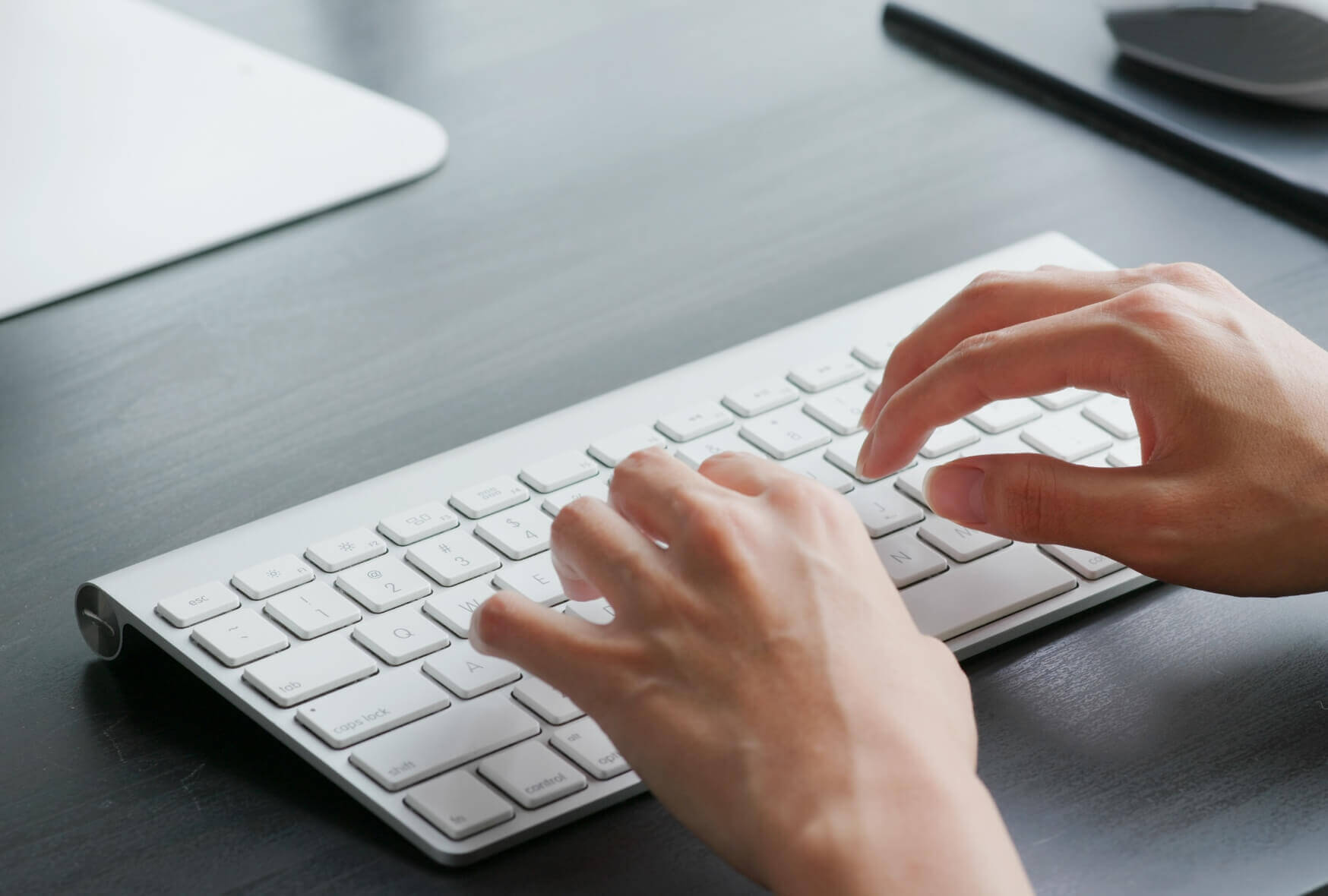 A woman type on computer at home