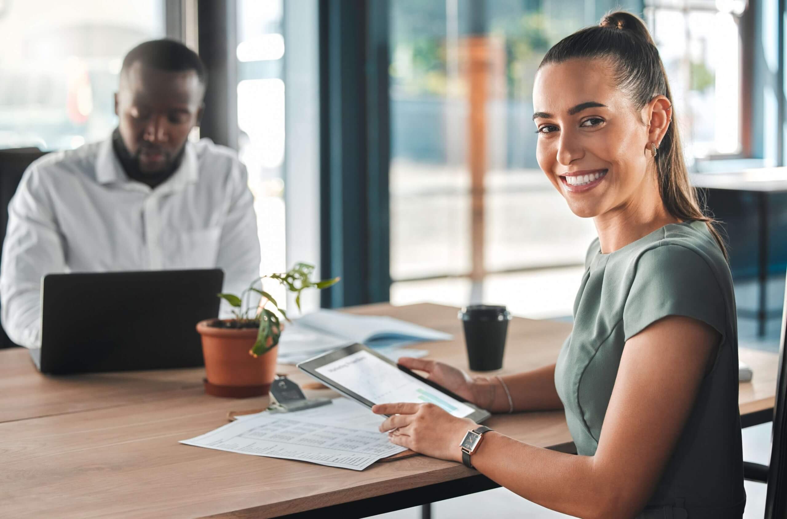 A women smiling while working with her workmates