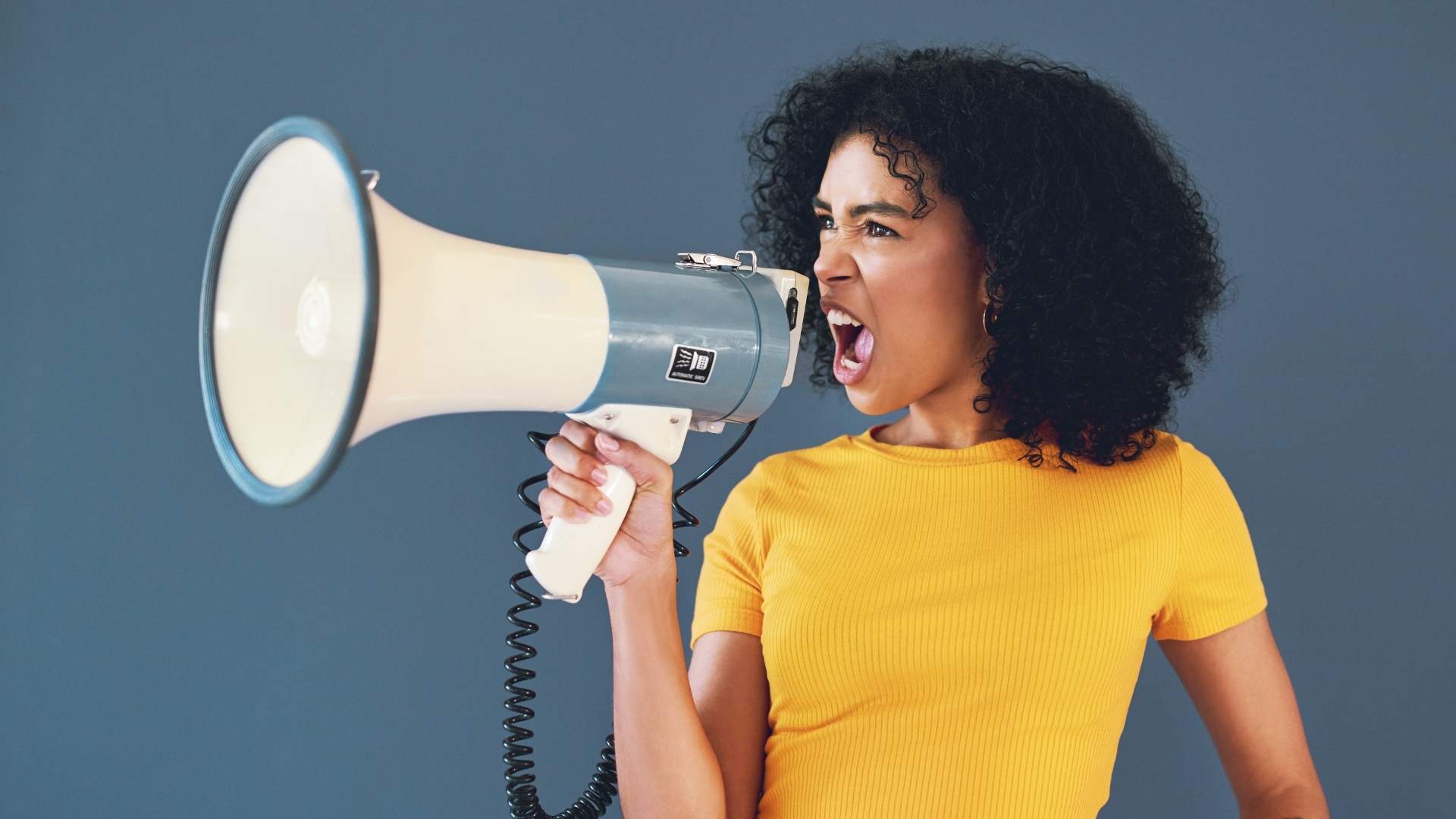 attractive young woman holding a megaphone