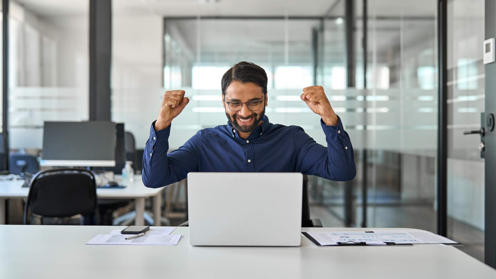 business man executive looking at computer feeling motivated