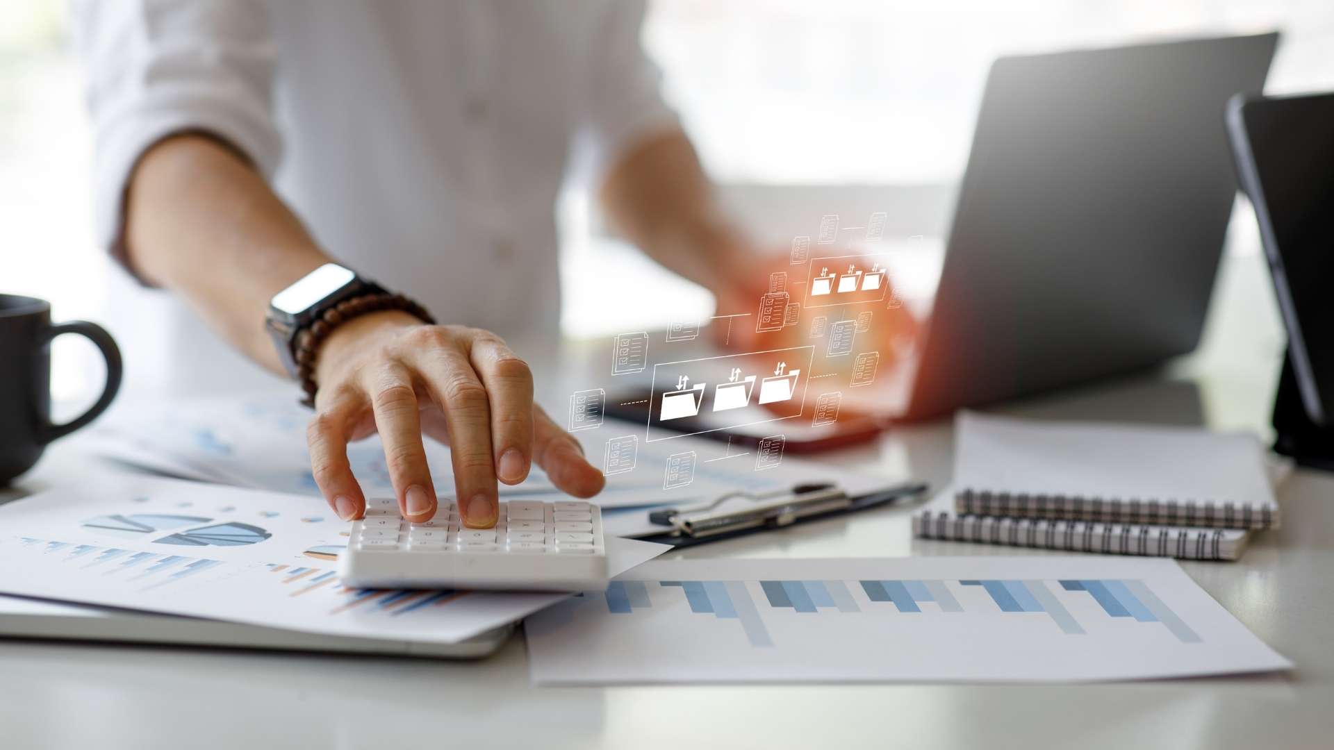 Businessman calculating on digital document on laptop