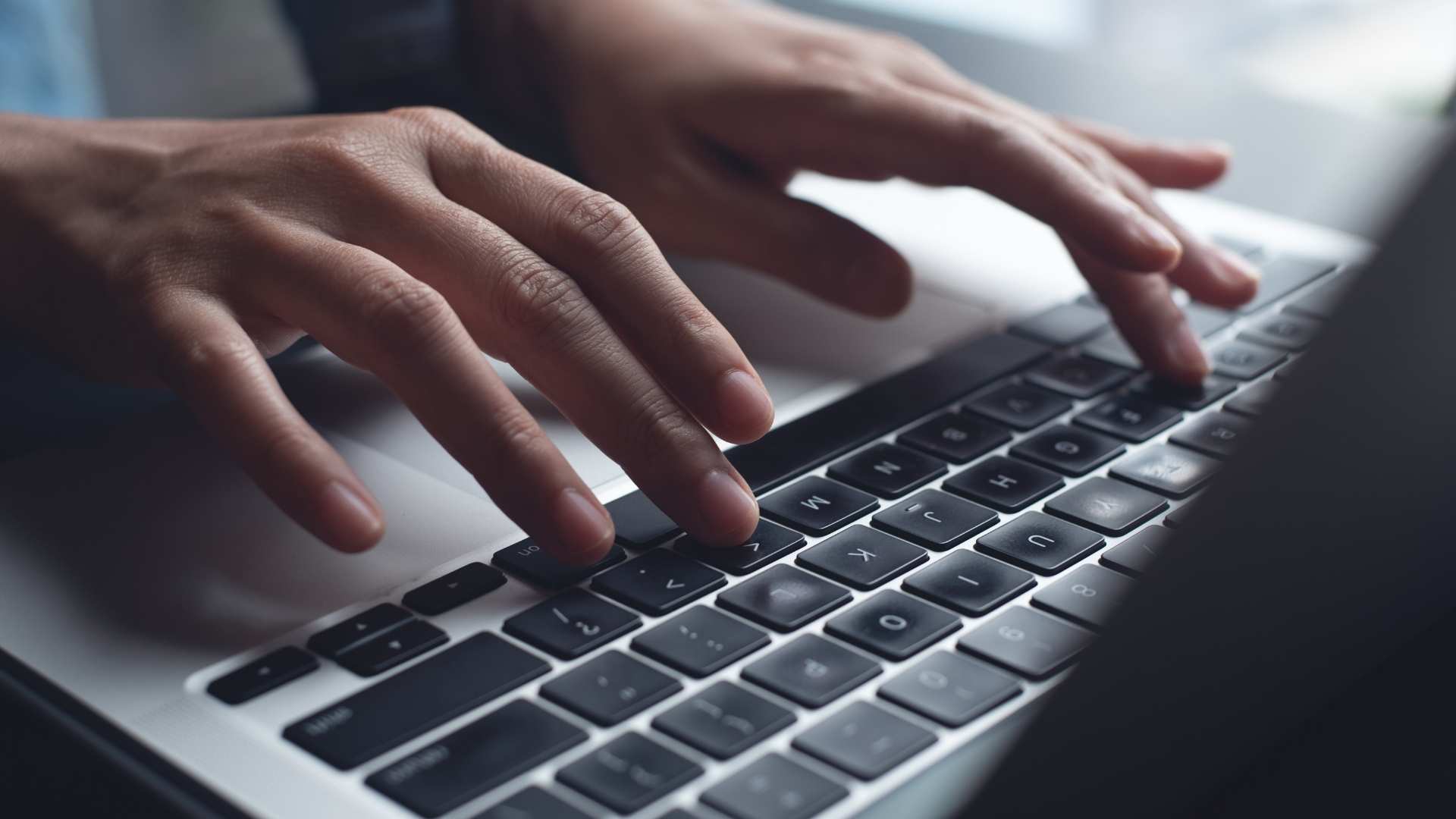 Close up of business woman hands typing on laptop computer