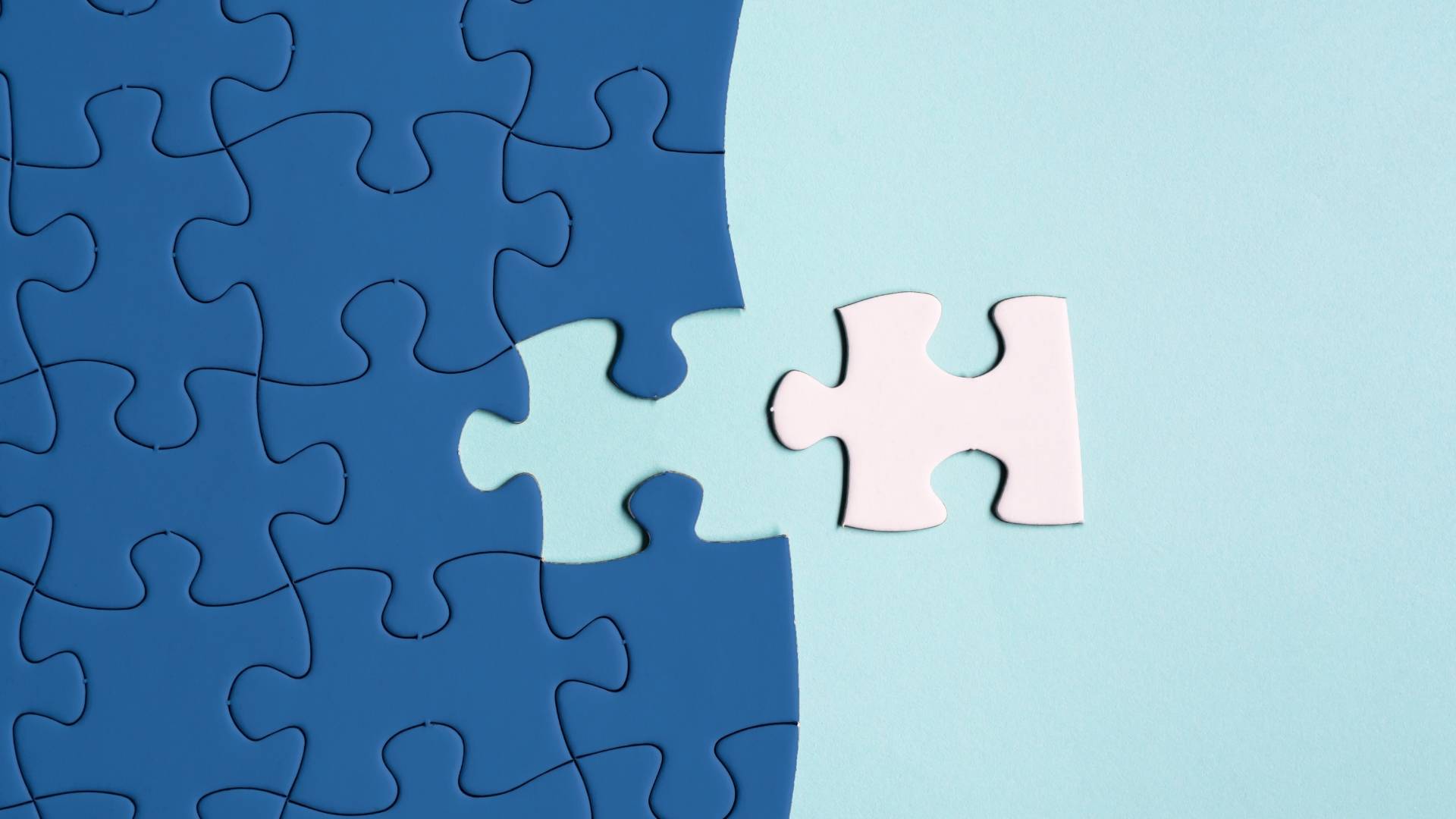 dark blue jigsaw puzzle with a piece missing