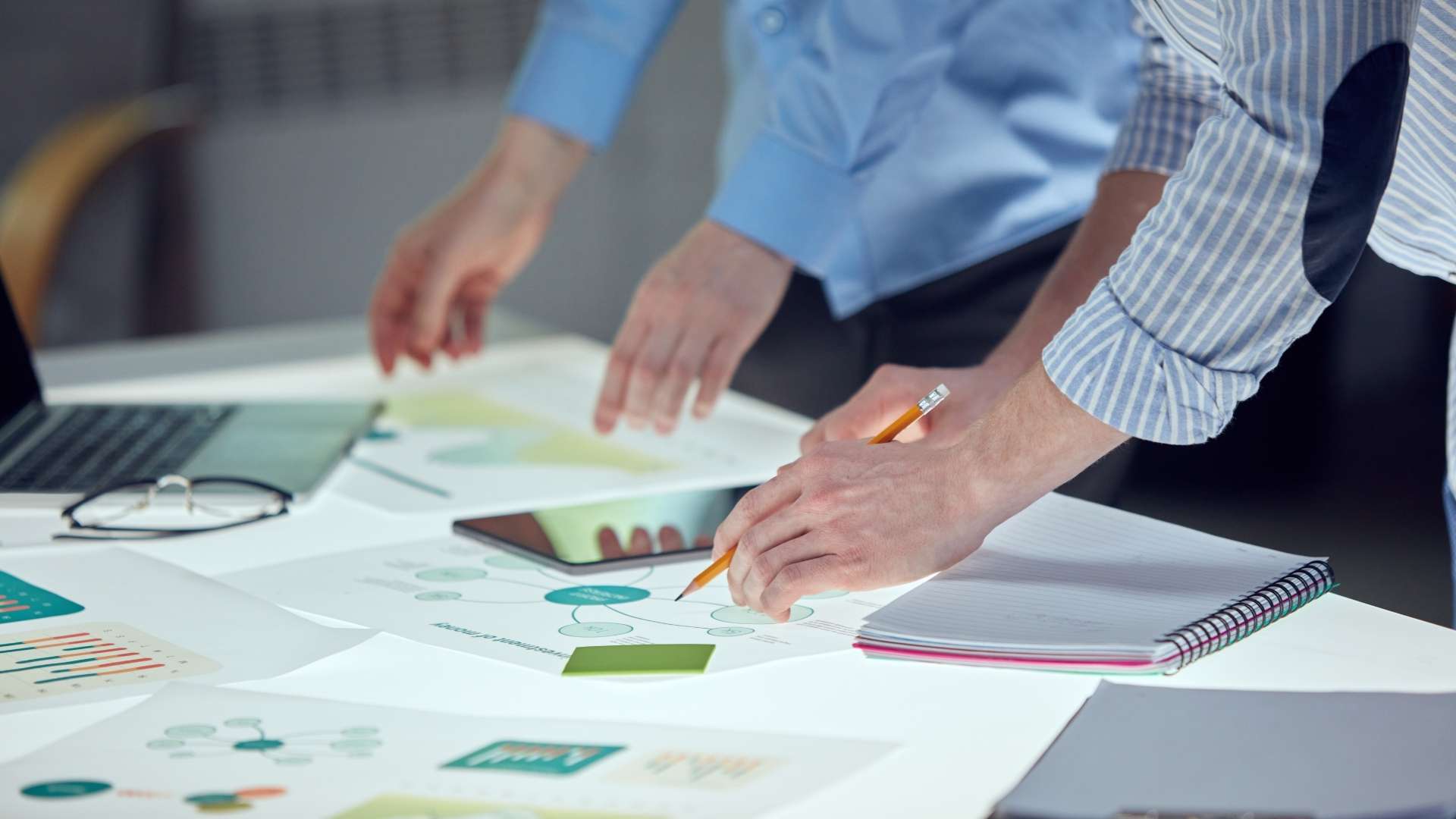 group of people brainstorming ideas over the table