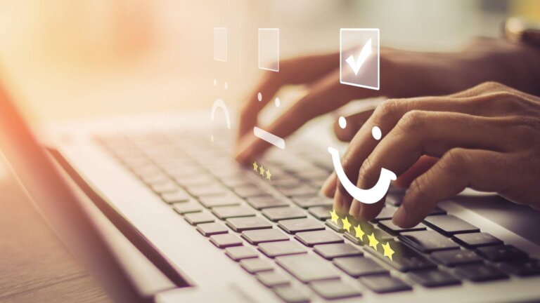 guy typing on his laptop with emoji icons on top