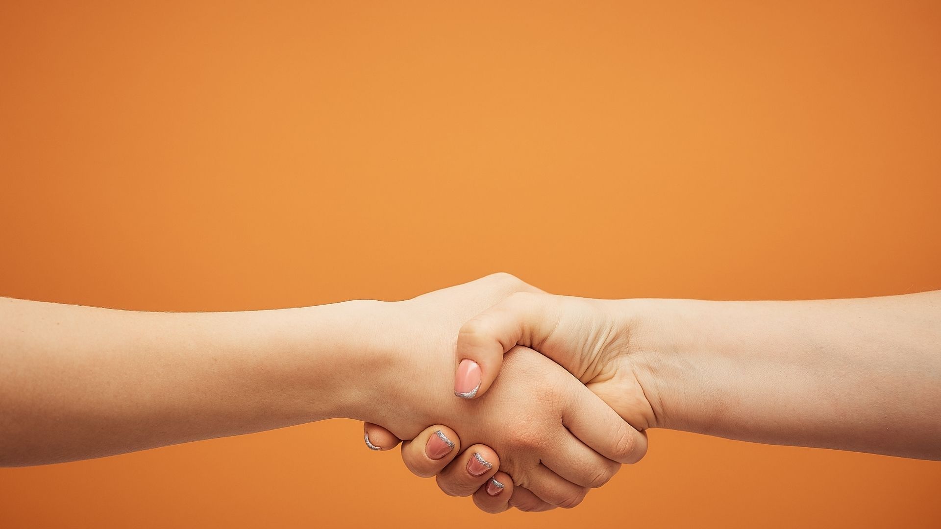 hand shaking in orange background