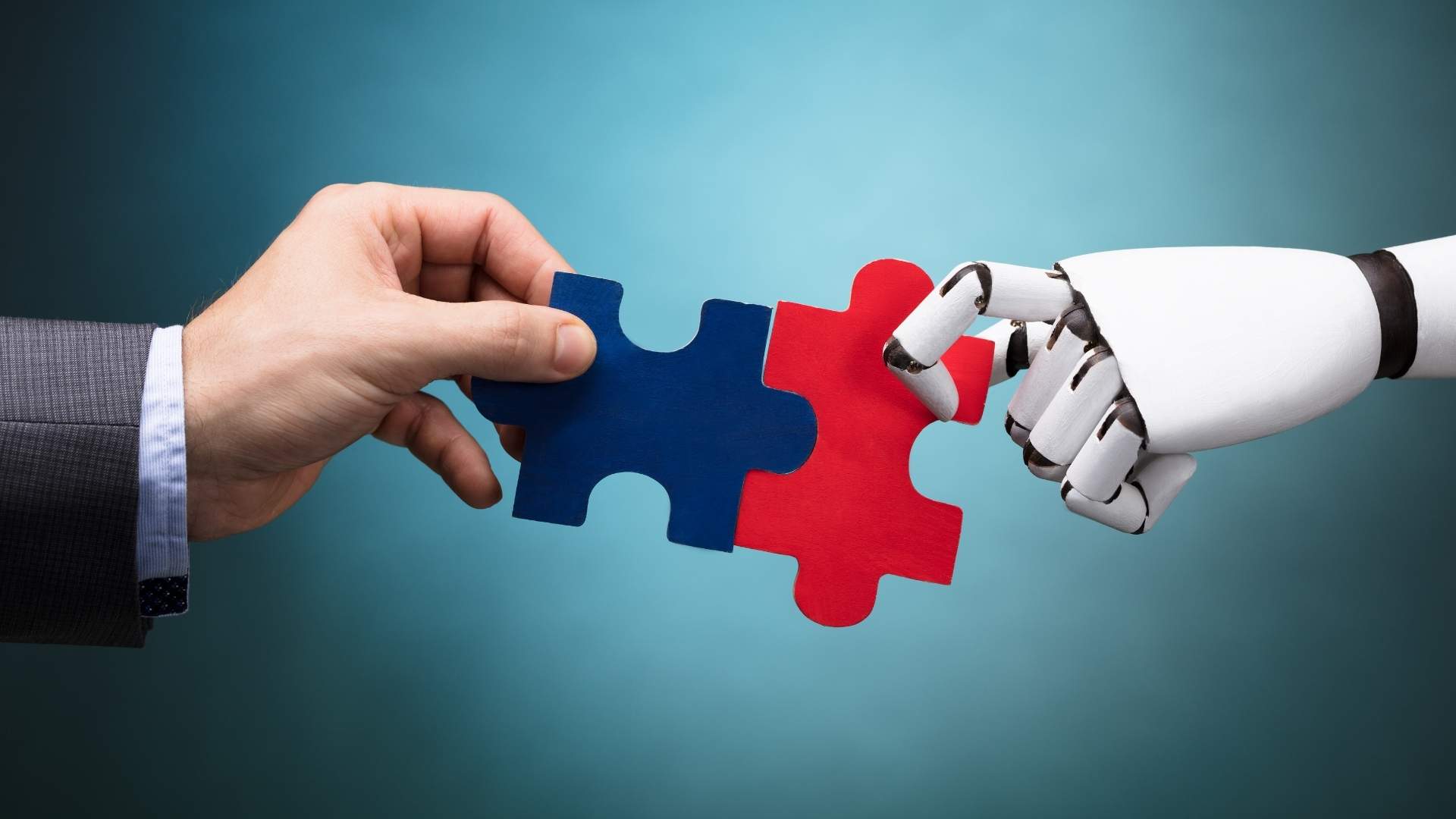 human and robot holding a jigsaw puzzle