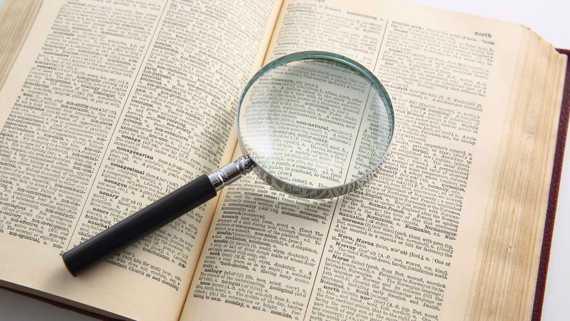 magnifying glass on top of a book