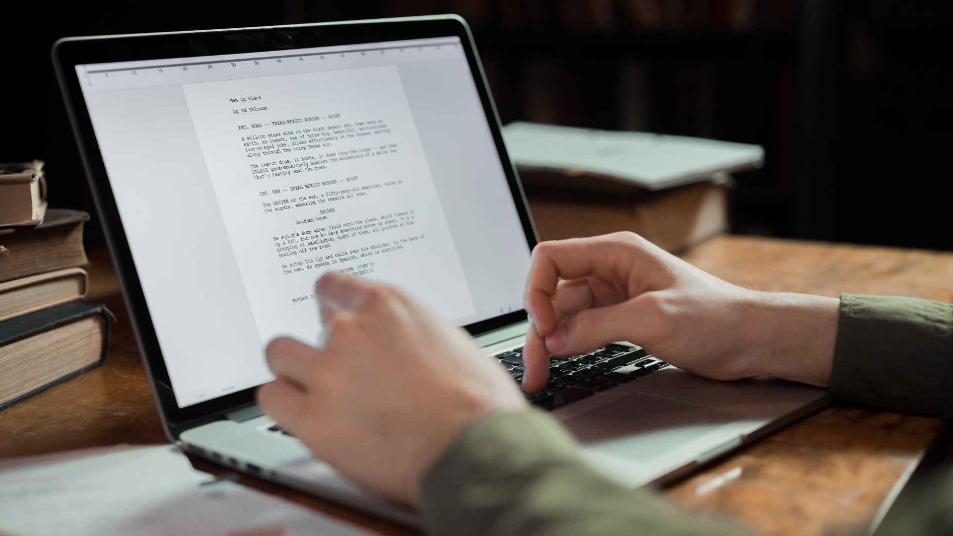 person writing a content on laptop