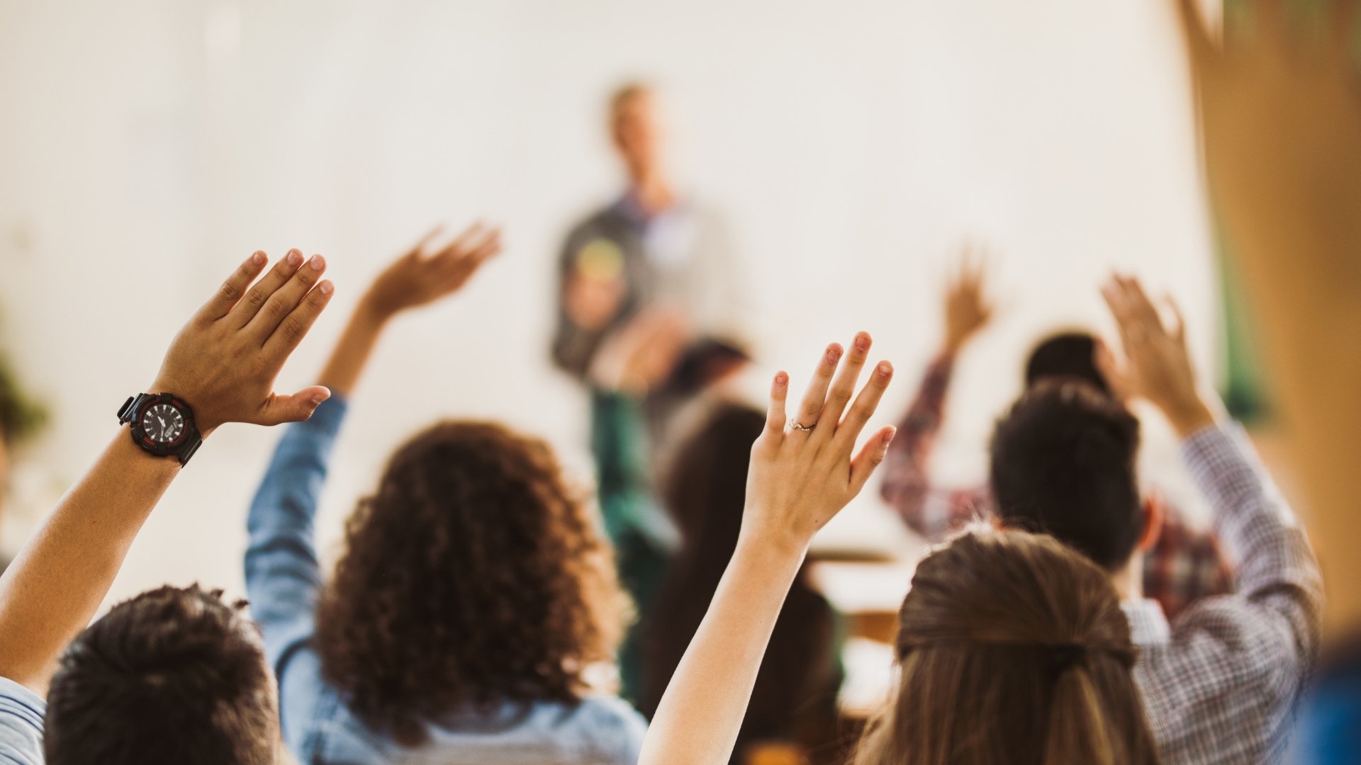 students raising hands