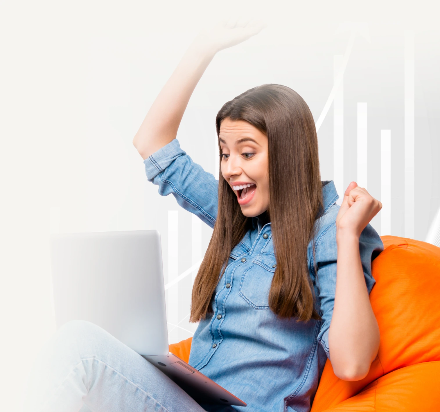 A cheerful cheery girl sitting in bag chair using laptop