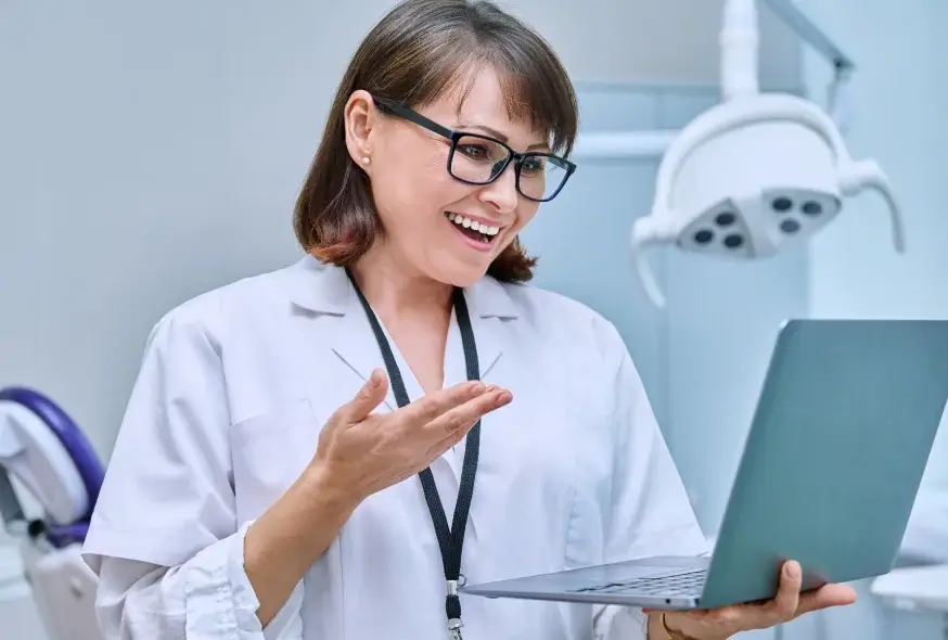 A happy dentist talking someone on the video call