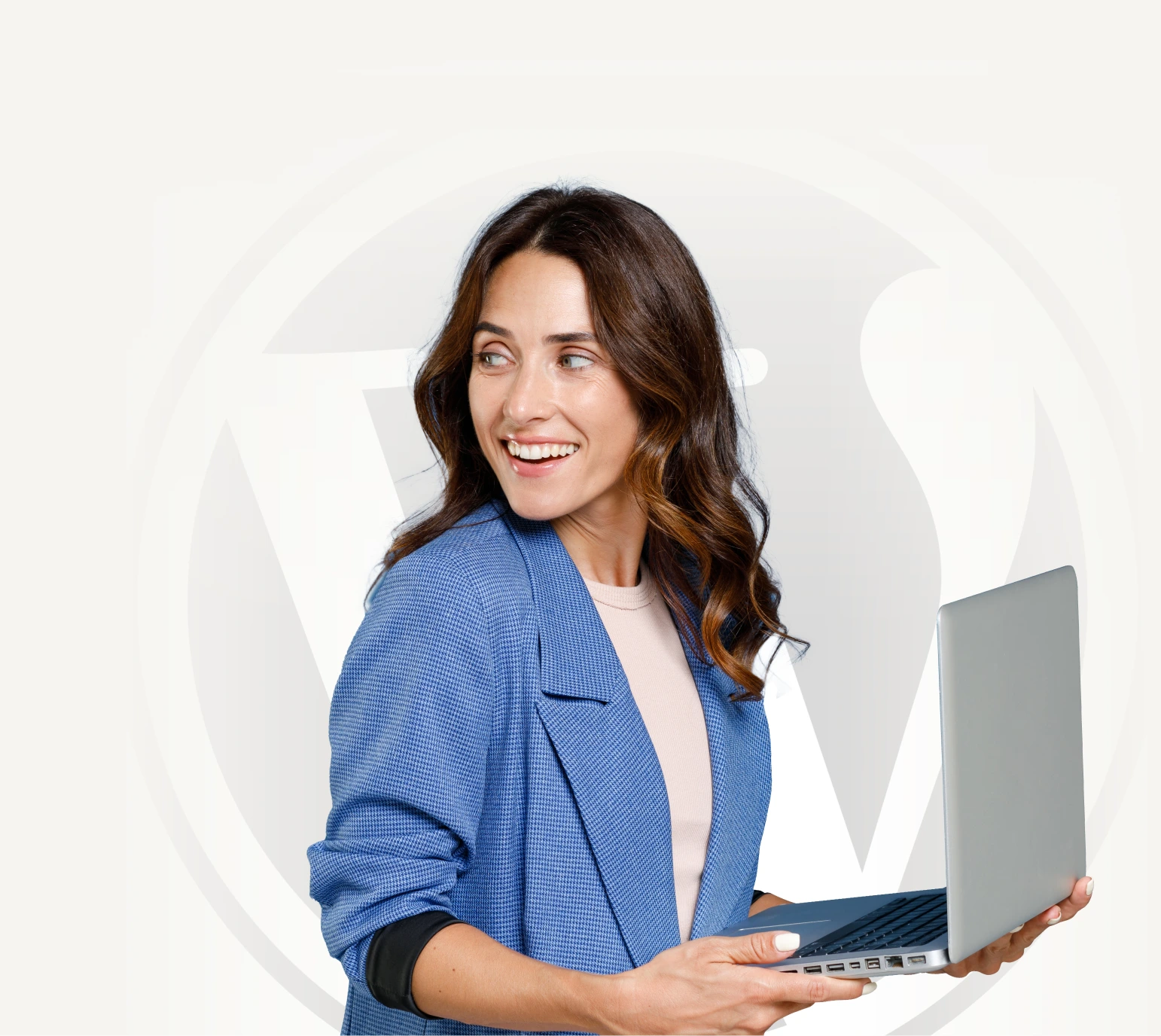 A person holding a laptop with a wordpress logo background
