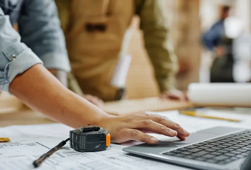 blurry persons verifying something on the laptop