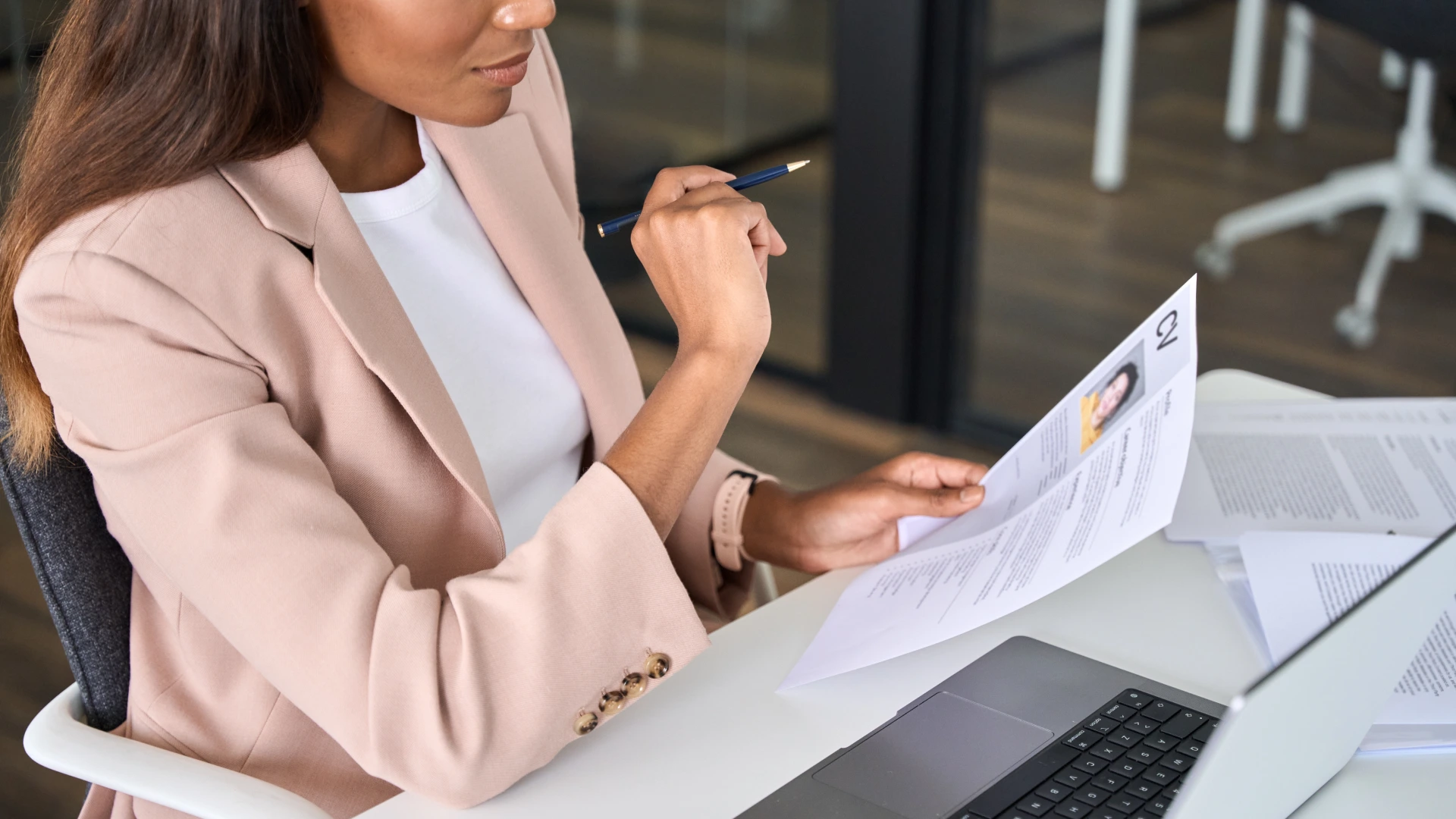 Close up view of female HR manager reading cv during virtual remote online job interview concept.