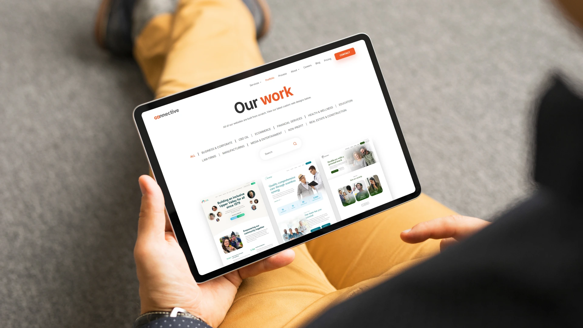 Man viewing connective portfolio website on tablet computer